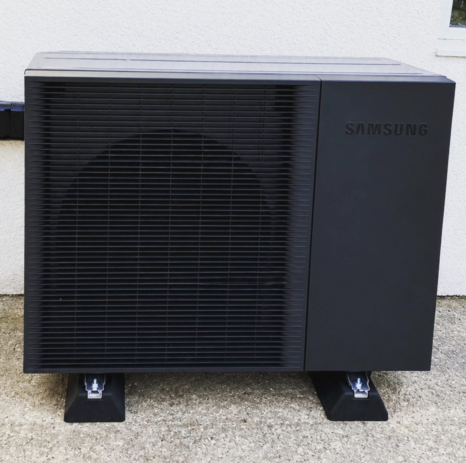 Samsung air source heat pump monobloc unit installed against a rendered wall